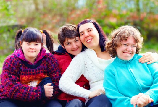 group of teens with disabilities having fun in a park