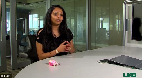 women sitting at a conference table with the smart bracelet device